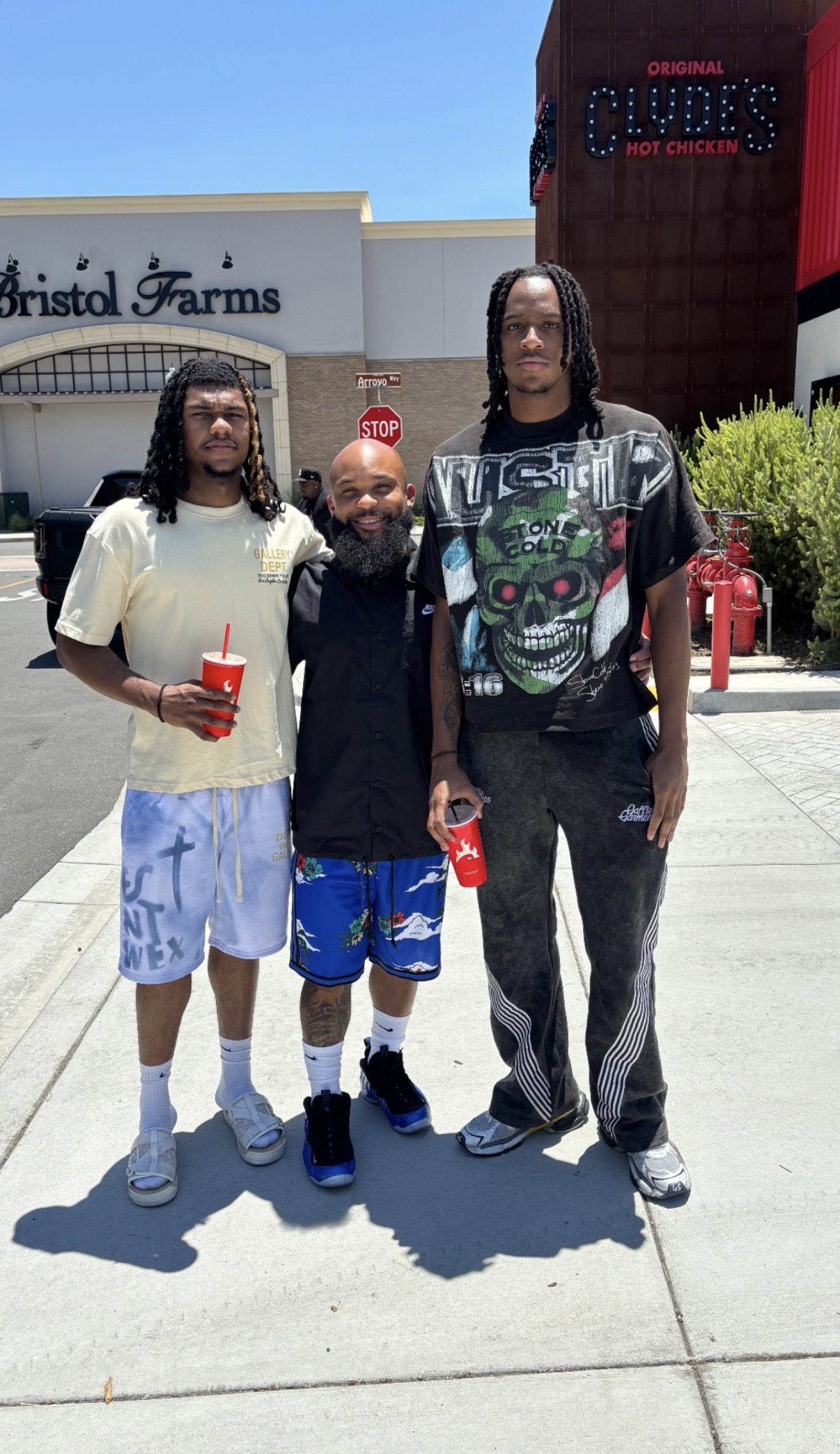 DBR mentor standing with young men during a community outing